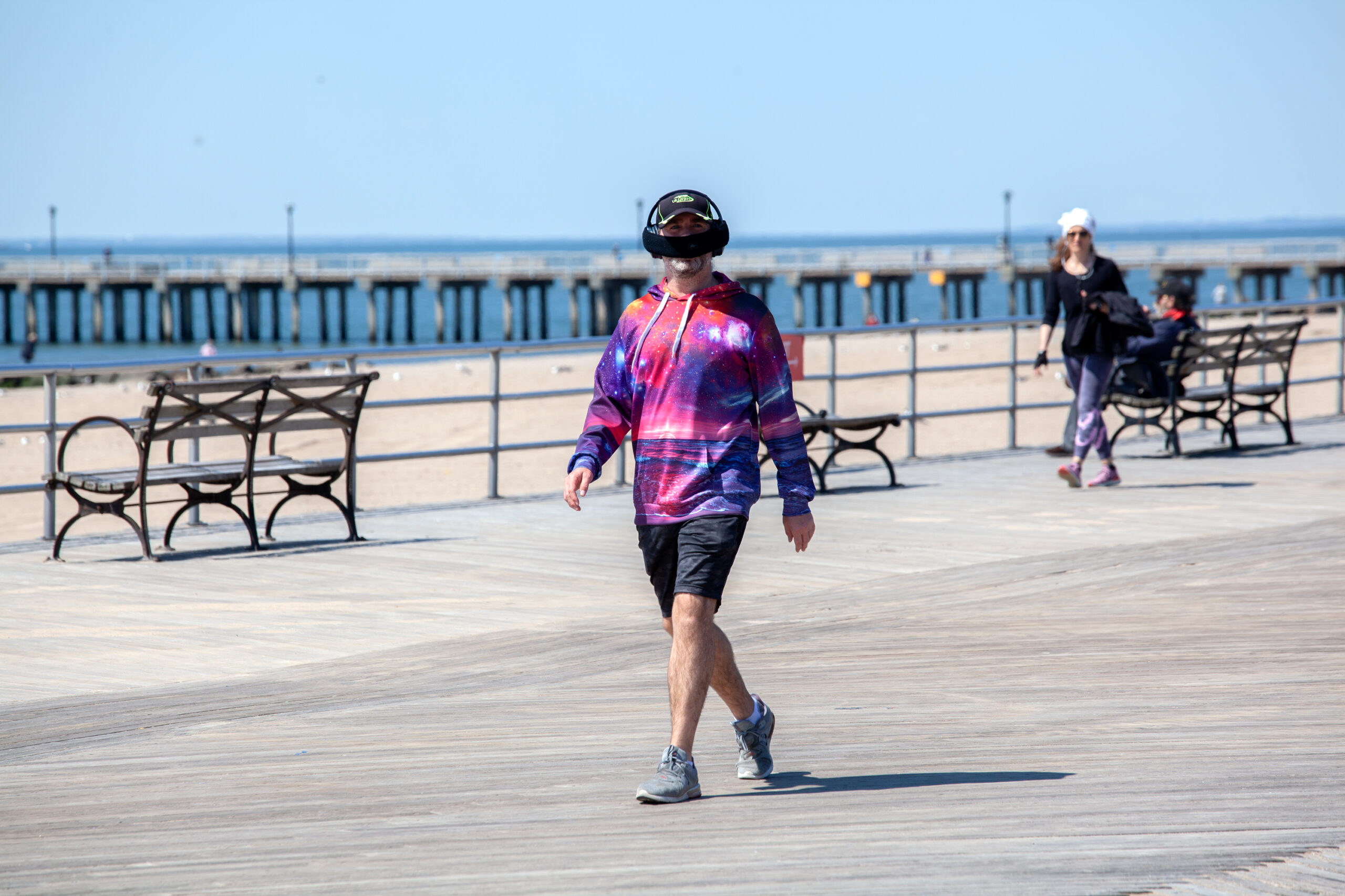 People enjoy the Coney Island boardwalk near Steeplechase Pier at the beginning of the pandemic, May 7, 2020.