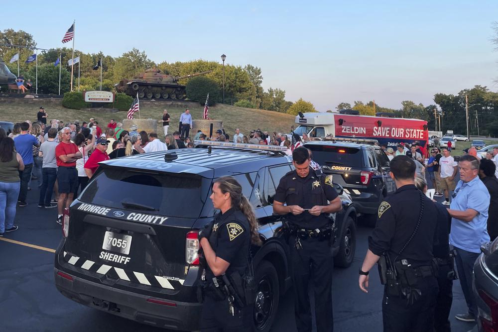 In this photo provided by Ian Winner, police officers work the scene after U.S. Rep. Lee Zeldin, the Republican candidate for New York governor, was assaulted by a man who apparently tried to stab him Thursday, July 21, 2022, in Fairport, N.Y. Zeldin escaped serious injury. (Ian Winner via AP)