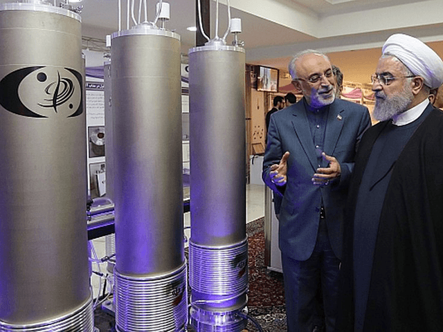 In this April 9, 2018, file photo, released by an official website of the office of the Iranian Presidency, President Hassan Rouhani listens to explanations on new nuclear achievements at a ceremony to mark 