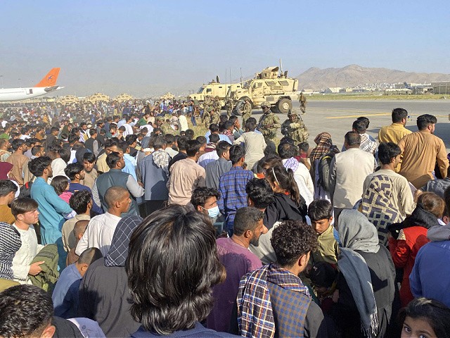 U.S soldiers stand guard along a perimeter at the international airport in Kabul, Afghanistan, Monday, Aug. 16, 2021. On Monday, the U.S. military and officials focus was on Kabulâ€™s airport, where thousands of Afghans trapped by the sudden Taliban takeover rushed the tarmac and clung to U.S. military planes deployed to fly out staffers of the U.S. Embassy, which shut down Sunday, and others. (AP Photo/Shekib Rahmani)
