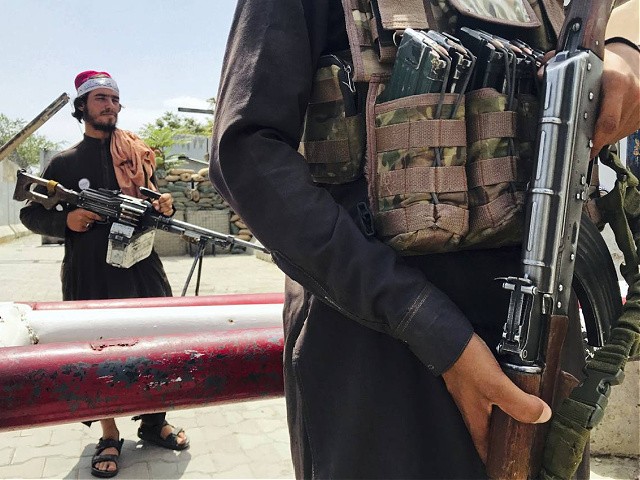 Taliban fighters stand guard at a checkpoint near the US embassy that was previously manned by American troops, in Kabul, Afghanistan, Tuesday, Aug. 17, 2021. The Taliban declared an 