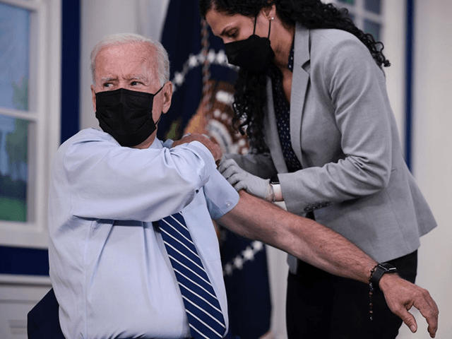 WASHINGTON, DC - SEPTEMBER 27: U.S. President Joe Biden rolls up his sleeve before receiving a third dose of the Pfizer/BioNTech Covid-19 vaccine in the South Court Auditorium in the White House September 27, 2021 in Washington, DC. Last week President Biden announced that Americans 65 and older and frontline workers who received the Pfizer-BioNTech COVID-19 vaccine over six months ago would be eligible for booster shots. (Photo by Anna Moneymaker/Getty Images)