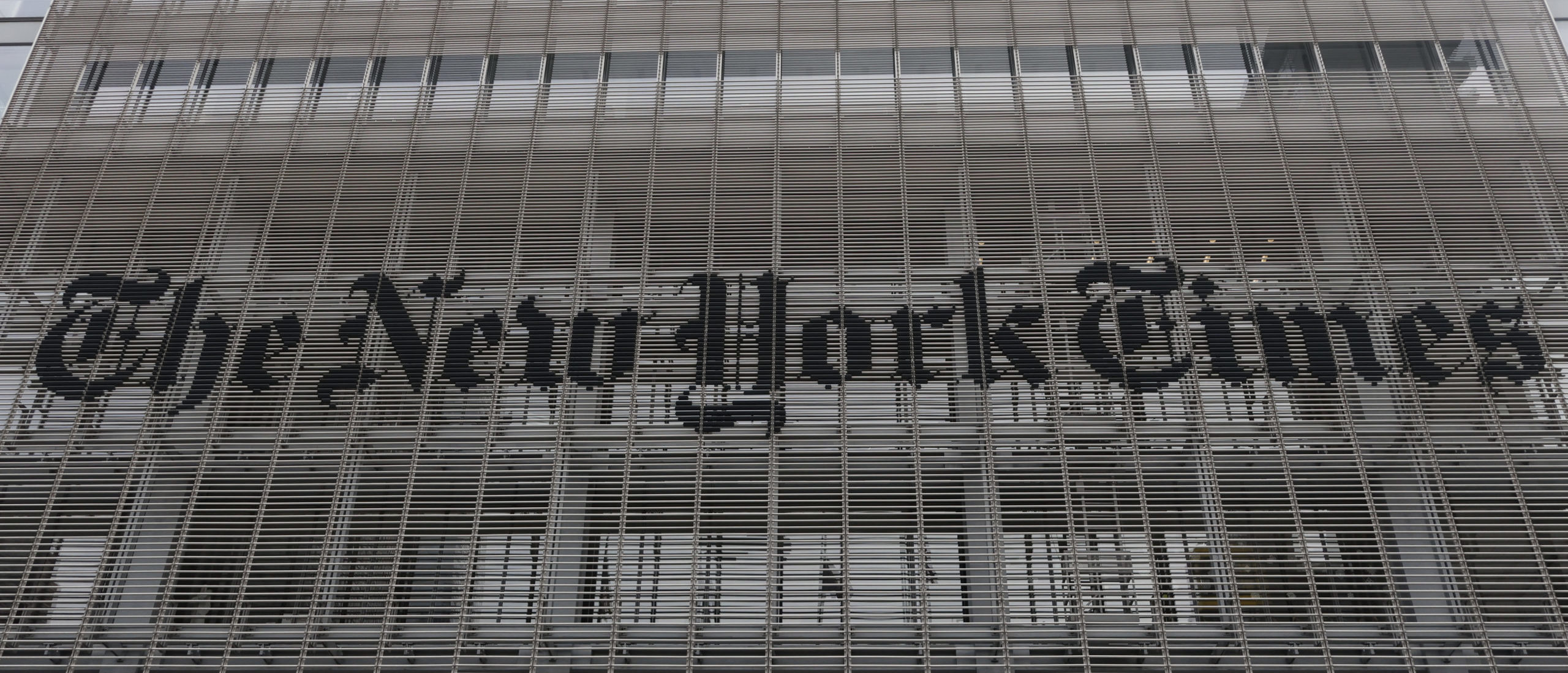 NEW YORK, NY - DECEMBER 30: The corporate logo for the New York Times is displayed on the front of their building on 8th Avenue on December 30, 2023, in New York City. (Photo by Gary Hershorn/Getty Images)