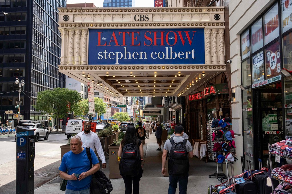 People walk past the Ed Sullivan theater, where 