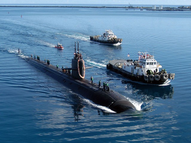 The attack submarine USS San Francisco is escorted by two harbor tugs as it returns to Apra Harbor, Guam, after a five-month deployment on June 4, 2004. (U.S. Navy photo/Photographer's Mate 2nd Class Mark A. Leonesio/Released)