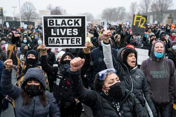 Demonstrators march to Brooklyn Center Police Department to protest the fatal shooting of Daunte Wright during a traffic stop in Brooklyn Center, Minn., on April 13, 2021. (John Minchillo/AP Photo)