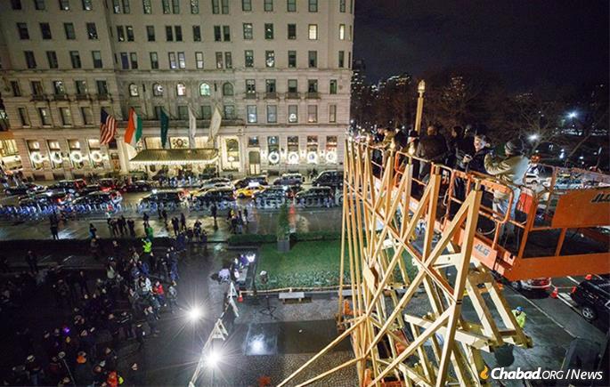 Although crowds will be at a minimum, New York City’s giant menorah on Fifth Avenue at 59th Street will be lit at the crossroads of the world each night of the eight-day holiday. (File Photo: Chaim Perl/Chabad.org)