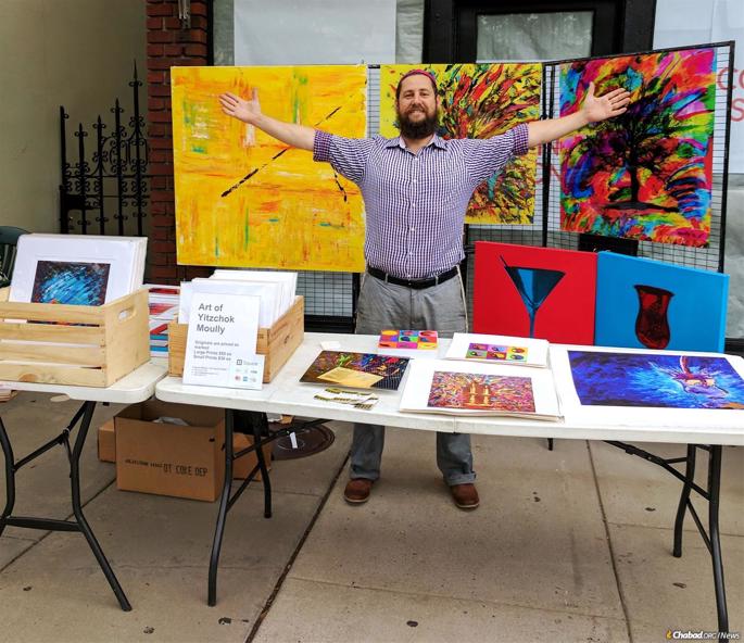 Surrounded by some of his work